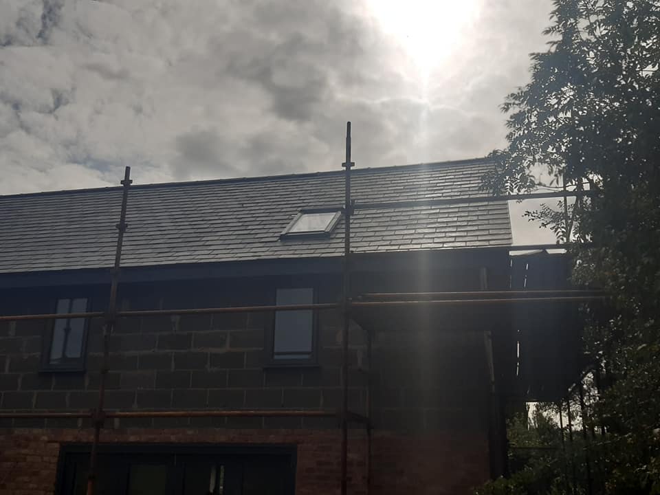 Slate roof installation with skylight