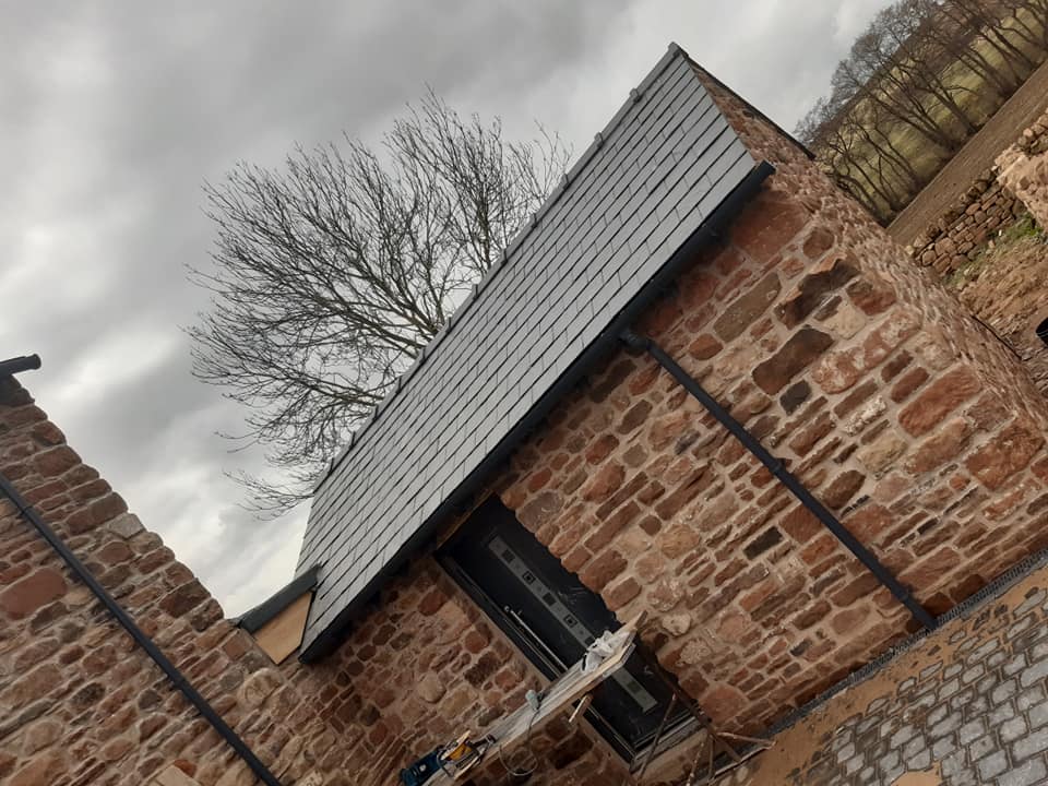 Barn conversion with new cladding and slate roof